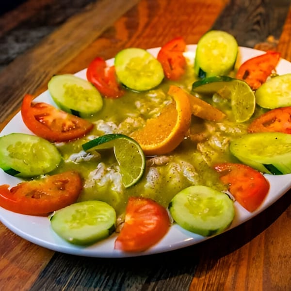 Boca Del Mar's Mexican ceviche with shrimp, green sauce, cucumbers, tomatoes, lime, and orange slices.